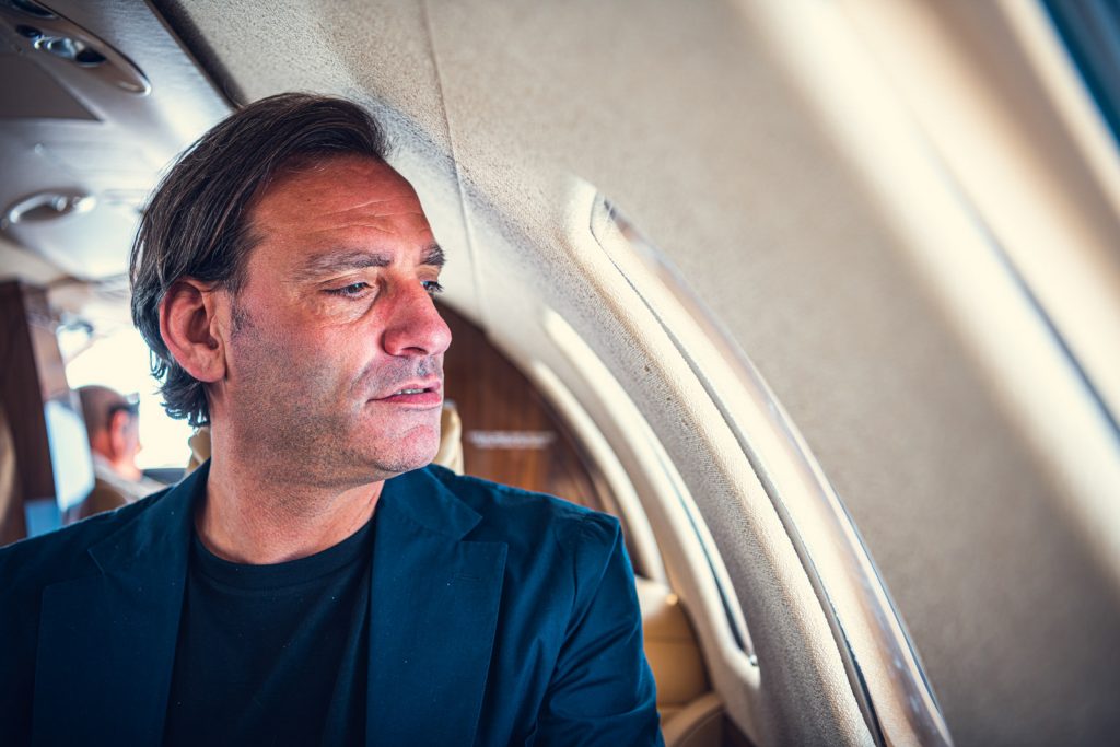 man sitting in private jet by jet view your partner in aviation